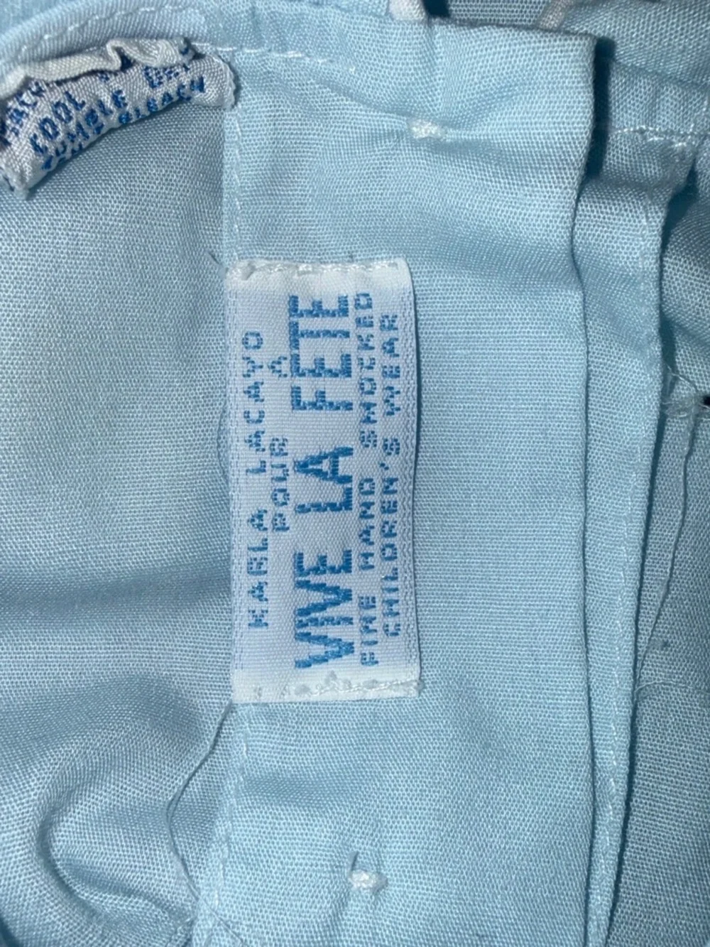 Baby blue smocked romper with embroidered floral design size 24m